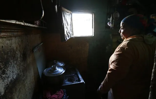 Om Mostafa, 50, cooks in her kitchen in the fishermen's village of the El Max area in the Mediterranean city of Alexandria October 18, 2014. (Photo by Amr Abdallah Dalsh/Reuters)