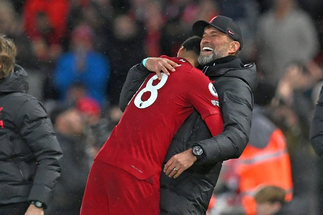 Liverpool's German manager Jurgen Klopp (R) reacts with Liverpool's Dutch striker Cody Gakpo (L) as he is substituted with Liverpool 5-0 up, during the English Premier League football match between Liverpool and Manchester United at Anfield in Liverpool, north west England on March 5, 2023. (Photo by Paul Ellis/AFP Photo)