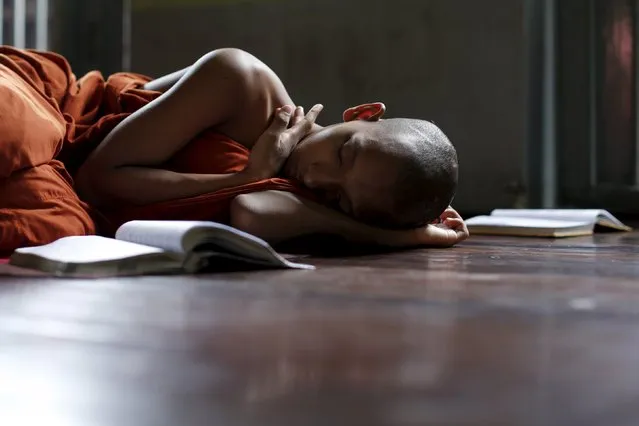 A Buddhist monk sleeps after morning prayers at the Masoyein monastery complex in Mandalay October 7, 2015. (Photo by Jorge Silva/Reuters)