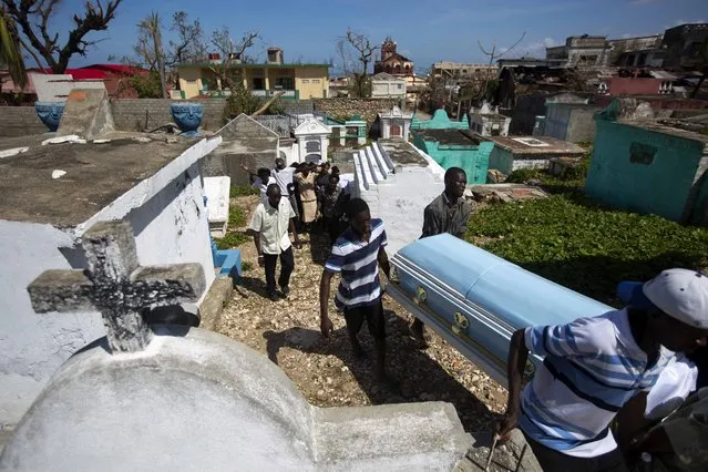 People carry the coffin of Roberto Laguerre to bury him at the cemetery in Jeremie, Haiti, Saturday, October 8, 2016. Roberto, 32, died when the wall of a church next door to his home fell during Hurricane Matthew. (Photo by Dieu Nalio Chery/AP Photo)