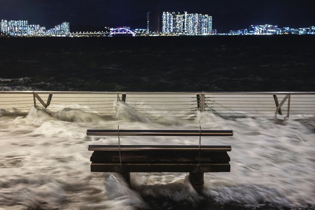Waves from Super Typhoon Ragasa crash onto a bench by the shore in Hong Kong, China, on September 23, 2025. (Photo by Tyrone Siu/Reuters)