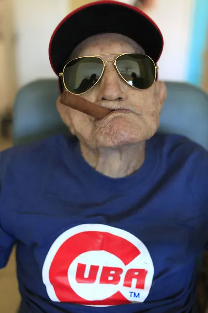 Conrado Marrero, the world's oldest living former major league baseball player, poses for a photo during his 102nd birthday bash at his home in Havana, Cuba, Thursday, April 25, 2013. In addition to his longevity, the former Washington Senator has much to celebrate this year. After a long wait, he finally received a $20,000 payout from Major League baseball granted to old-timers who played between 1947 and 1979. The money had been held up since 2011 due to issues surrounding the 51-year-old U.S. embargo on Cuba, which prohibits most bank transfers to the Communist-run island. But the payout finally arrived in two parts, one at the end of last year, and the second a few months ago, according to Marrero's family. (Photo by Franklin Reyes/AP Photo)