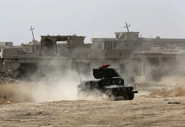 Iraqi forces are deployed during an offensive to retake Mosul from Islamic State militants outside Mosul, Iraq, Monday, October 17, 2016. Columns of Iraqi and Kurdish forces backed by U.S.-led airstrikes slowly advanced on Mosul from several directions on Monday, launching a long-awaited operation to retake Iraq's second largest city from the Islamic State group. (Photo by Khalid Mohammed/AP Photo)