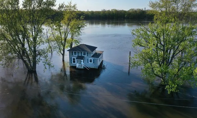 In this aerial, a home is surrounded by floodwater from the Mississippi River on May 03, 2023 in Albany, Illinois. According to the National Weather Service, the Mississippi River in the area is expected to remain at major flood stage into next week. (Photo by Scott Olson/Getty Images)