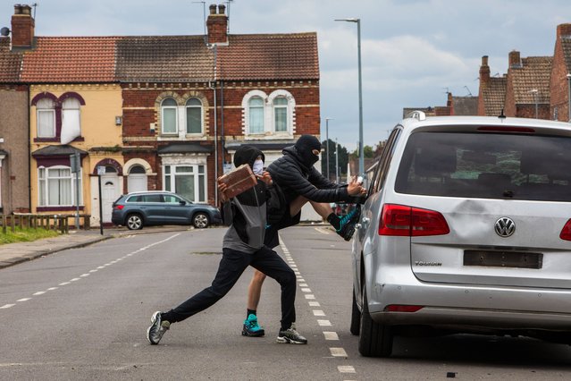 A far-right protest in Middlesbrough, England turns violent, causing damage to property and cars on August 4, 2024. Running street battles took place with the police and members of the Muslim community. For Cleveland police it was the second time in a week that they have had to deal with riots after a night of disorder in Hartlepool last Wednesday. (Photo by Gary Calton/The Observer)