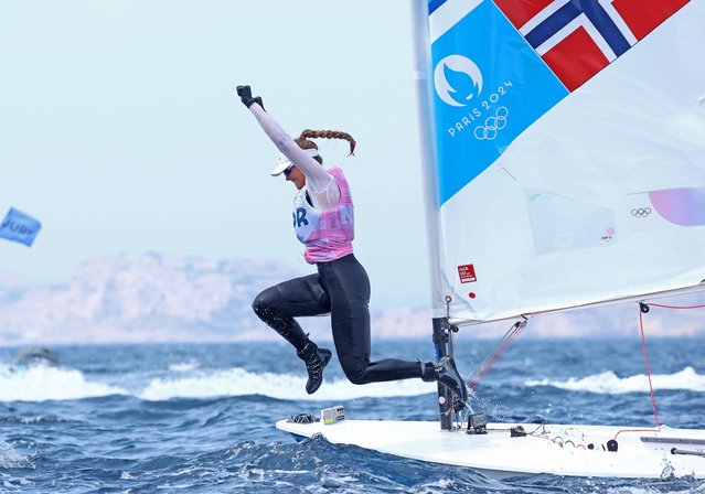 Bronze medallist Norway's Line Flem Hoest jumps into the water as she celebrates at the end of the women's ILCA 6 single-handed dinghy medal race during the Paris 2024 Olympic Games sailing competition at the Roucas-Blanc Marina in Marseille on August 7, 2024. (Photo by Lisi Niesner/Reuters)