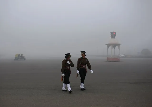 Indian soldiers walk before the start of their rehearsal for the Republic Day parade on a foggy winter morning in New Delhi January 16, 2015. (Photo by Ahmad Masood/Reuters)