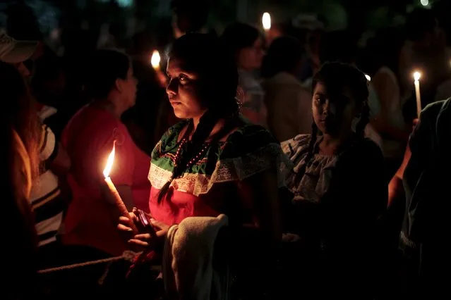 Devotees light candles to celebrate the Day of the Virgin of Guadalupe outside the Basilica of Guadalupe in San Salvador, El Salvador December 12, 2015. (Photo by Jose Cabezas/Reuters)