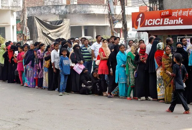 People queue to deposit or exchange their old  high denomination banknotes outside a bank in Allahabad, India, November 16, 2016. (Photo by Jitendra Prakash/Reuters)