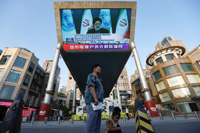 A giant screen broadcasts news footage of Iranian President Ebrahim Raisi attending via video link the meeting of the Shanghai Cooperation Organisation Council of Heads of State, in Beijing, China on July 4, 2023. (Photo by Tingshu Wang/Reuters)