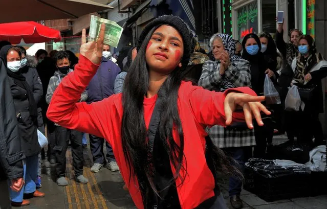 An Iranian girl wearing a costume inspired in the fictional folklore character Hajji Firuz, dances in Tehran on March 17, 2021 as Iranians prepare to celebrate Noruz, the Iranian New Year. Noruz, “new day” in Persian, is the New Year festivity celebrated in Iran as well as in Afghanistan and Kurdish regions in several countries. It begins with the spring equinox and symbolises rebirth. (Photo by Atta Kenare/AFP Photo)