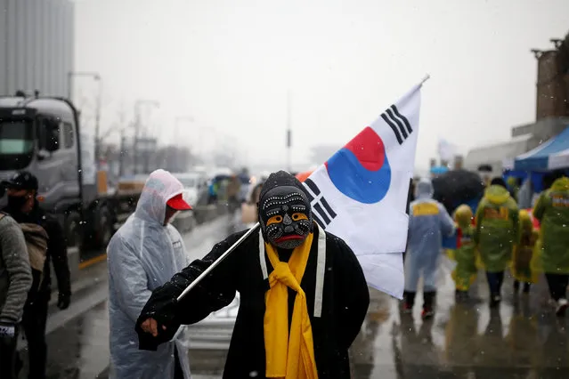 A man in costume attends a protest calling for Park Geun-hye to step down as it snows in Central Seoul, South Korea, November 26, 2016. (Photo by Kim Kyung-Hoon/Reuters)