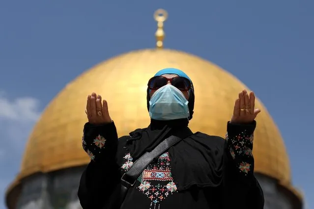 A Palestinian woman prays in front of the Dome of the Rock in the compound known to Muslims as Noble Sanctuary and to Jews as Temple Mount in Jerusalem's Old City, on the first Friday of the holy month of Ramadan, as coronavirus disease (COVID-19) restrictions ease around the country, April 16, 2021. (Photo by Ammar Awad/Reuters)