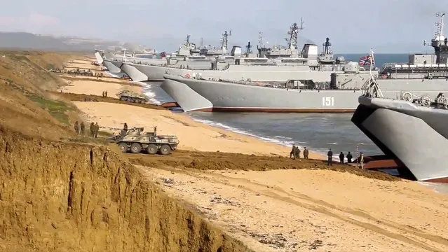 This handout photo taken from a video released on Friday, April 23, 2021 by Russian Defense Ministry Press Service shows, Russian troops board landing vessels after drills in Crimea. Russian Defense Minister Sergei Shoigu on Thursday ordered troops back to their permanent bases after a massive military buildup that caused Ukrainian and Western concerns. (Photo by Russian Defense Ministry Press Service via AP Photo)