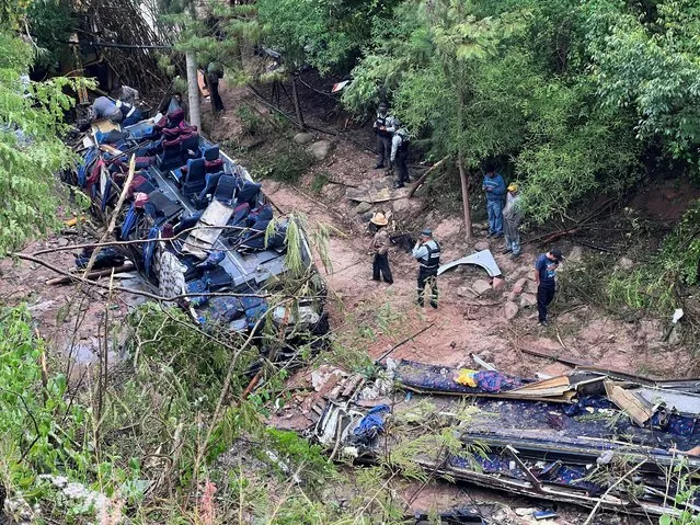 Authorities and volunteers work at the site where a bus traveling from Mexico City through southern Oaxaca state crashed into a ravine killing several people, in Magdalena Penasco, Mexico on July 5, 2023. (Photo by Jose de Jesus Cortes/Reuters)