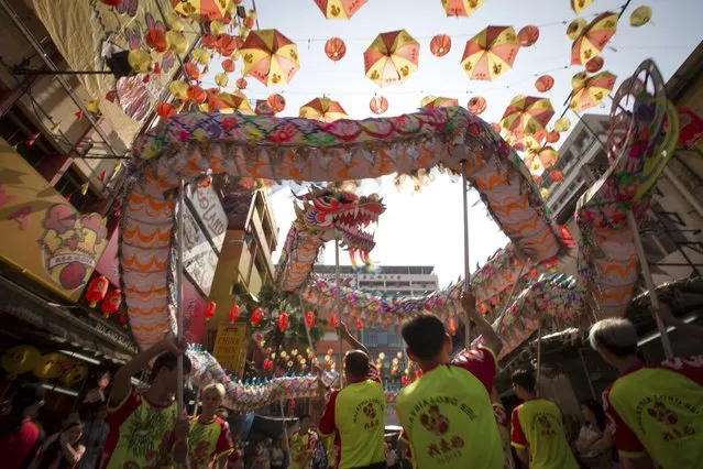 A dragon dance is performed at China Town on the last day of the Chinese Lunar New Year celerations in Kuala Lumpur, Malaysia, Thursday, March 5, 2015. (AP Photo/Vincent Thian)