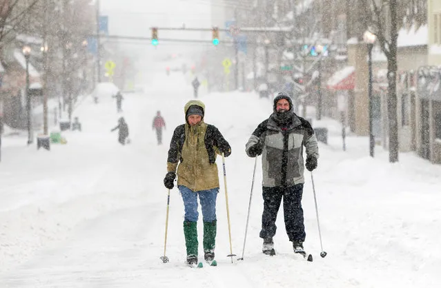 West Virginia University college students ski on High Street in Morgantown, W.Va. Saturday, January 23, 2016, Millions of Americans awoke Saturday to heavy snow outside their doorsteps as a mammoth winter storm crawled up the East Coast, making roads impassable, shutting down mass transit and bringing the nation's capital and its largest city to a standstill. (Photo by Ben Queen/AP Photo)