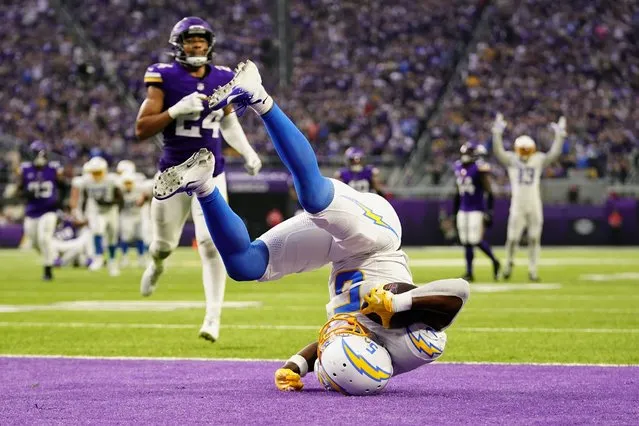 Los Angeles Chargers wide receiver Joshua Palmer (5) flips in the end zone during a 30-yard touchdown reception in the second half of an NFL football game against the Minnesota Vikings, Sunday, September 24, 2023, in Minneapolis. (Photo by Abbie Parr/AP Photo)