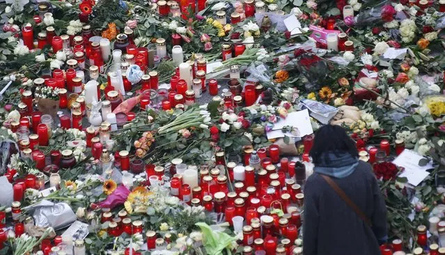 Flowers and candles are placed near the Christmas market in Berlin, Germany, December 21, 2016, after a truck ploughed through a crowd at the Christmas market on Monday night. (Photo by Hannibal Hanschke/Reuters)