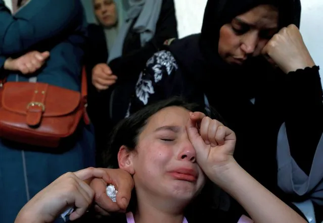 The sister and mother of Palestinian teenager Ahmed Zahi Bani Shamsa, who, according to medics, died of wounds he sustained by Israeli forces during clashes, mourn during his funeral in Beita in the Israeli-occupied West Bank on June 17, 2021. (Photo by Mohamad Torokman/Reuters)