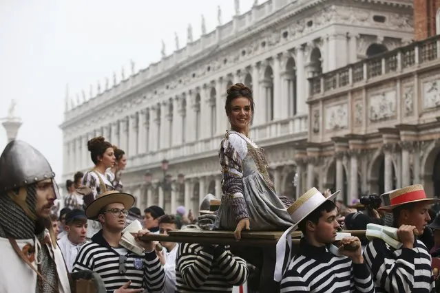 The traditional “Marie”, women wearing historical costumes, are carried during the “Festa delle Marie” procession in San Marco Square during the Venice Carnival January 30, 2016. (Photo by Alessandro Bianchi/Reuters)