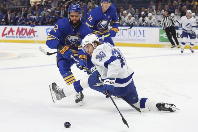 Buffalo Sabres left wing Jordan Greenway (12) and Tampa Bay Lightning left wing Brandon Hagel (38) collide during the second period of an NHL hockey game Tuesday, October 17, 2023, in Buffalo, N.Y. (Photo by Jeffrey T. Barnes/AP Photo)