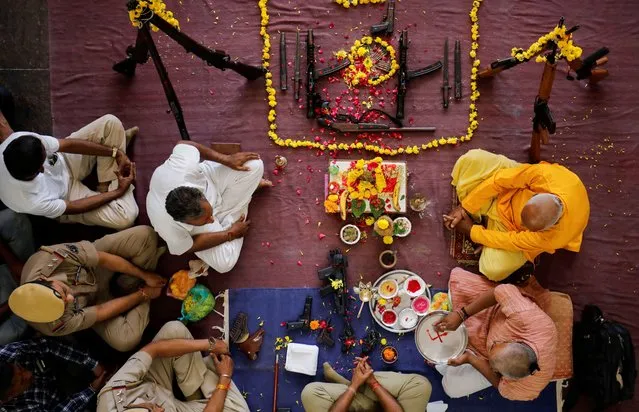 Police officers offer prayers to their weapons as part of a ritual at their headquarters on the occasion of Dussehra, or Vijaya Dashami festival in Ahmedabad, India on October 24, 2023. (Photo by Amit Dave/Reuters)