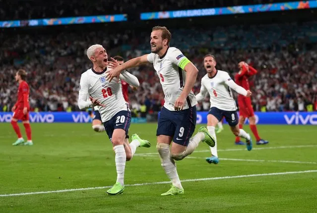 Harry Kane of England celebrates with Phil Foden after scoring their side's second goal during the UEFA Euro 2020 Championship Semi-final match between England and Denmark at Wembley Stadium on July 07, 2021 in London, England. (Photo by Laurence Griffiths/Pool via Reuters)