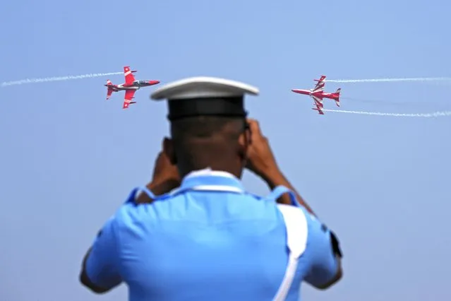Indian Air Force's aerobatic team Suryakiran perform during the graduation ceremony of new cadets on the outskirts of Hyderabad, India, Sunday, December 17, 2023. A total of 213 cadets were commissioned as officers in flying and ground duty branches on completion of their training Sunday. (Photo by Mahesh Kumar A./AP Photo)
