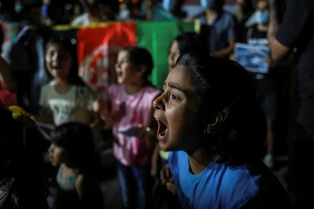 A girl shouts slogans during a demonstration of Afghan migrants against the Taliban takeover of Afghanistan, on the island of Lesbos, Greece, August 16, 2021. (Photo by Elias Marcou/Reuters)