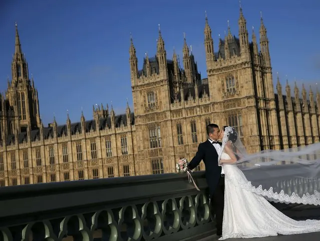 A chinese couple poses for a wedding photographer in front of the Big Ben clocktower and the Houses of Parliament in central London, Britain May 7, 2015. (Photo by Stefan Wermuth/Reuters)