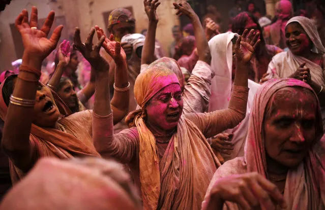 Widows daubed in colours dance as they take part in the Holi celebrations organised by non-governmental organisation Sulabh International at a temple at Vrindavan, in the northern state of Uttar Pradesh, India, March 21, 2016. (Photo by Anindito Mukherjee/Reuters)