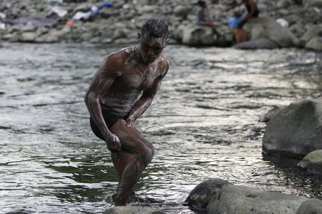 A Cuban migrant washes himself at the river in Paso Conoa, at the border with Costa Rica March 20, 2016. (Photo by Carlos Jasso/Reuters)