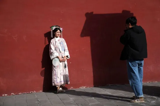 A visitor dressed in a period costume poses for photo at the Forbidden City in Beijing, China, Saturday, March 16, 2024. (Photo by Tatan Syuflana/AP Photo)