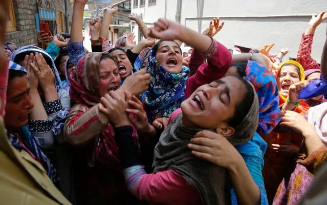 Female Kashmiri Muslim protester wail and shout slogans as police try to stop their protest march on the outskirts of Srinagar, the summer capital of Indian Kashmir, 13 May 2019. Protests erupted at several places on the second consecutive day in Indian Kashmir against the alleged rape of a three-year-old girl by a local boy at Malikpora, Trehgam area of Sumbal in north Kashmir's Bandiporoa district on 08 May 2019. The protesters were demanding exemplary punishment to the accused who has been arrested by police. (Photo by Farooq Khan/EPA/EFE/Rex Features/Shutterstock)