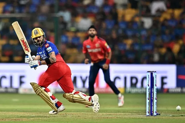 Royal Challengers Bengaluru's Virat Kohli watches the ball after playing a shot during the Indian Premier League (IPL) Twenty20 cricket match between Royal Challengers Bengaluru and Punjab Kings at the M. Chinnaswamy Stadium in Bengaluru on March 25, 2024. (Photo by Idrees Mohammed/AFP Photo)