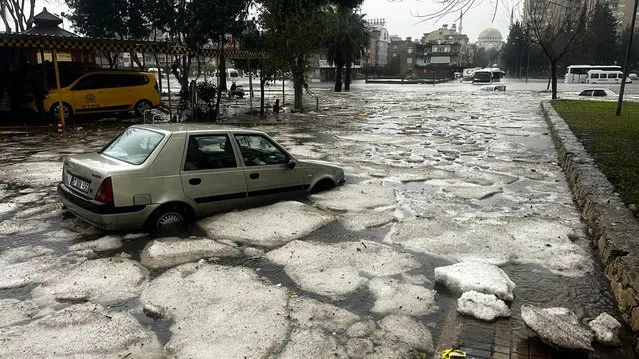 Vehicles are stranded during floods after heavy rains in Antalya, southern Turkey, Tuesday, February 13, 2024. (Photo by Dia Images via AP Photo)