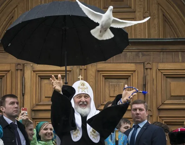 Russian Orthodox Church Patriarch Kirill, center, releases birds at Annunciation Cathedral in the Moscow's Kremlin in Moscow, Russia, Thursday, April 7, 2016, to mark the Russian Orthodox holiday of the Annunciation. (Photo by Alexander Zemlianichenko/AP Photo)