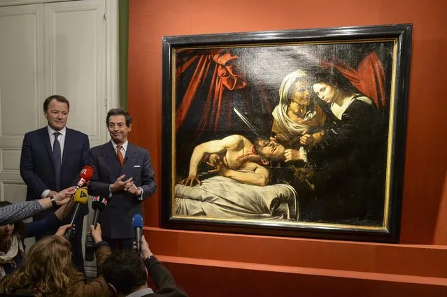 Art expert Eric Turquin (R) and Auctioneer Marc Labarbe (L) pose for photographs as they present the piece “Judith Beheading Holofernes” allegedly painted by Italian artist Michelangelo Merisi da Caravaggio during a press conference in Paris, France, 12 April 2016. Found in the attic of a house in Toulouse in April 2014, the masterpiece could be estimated at 120 million euros. A certified version of “Judith Beaheading Holofernes” by Caravaggio is on display at the National Gallery of Ancient Art in Rome; the second version disappeared early in 17th century. (Photo by Jeremy Lempin/EPA)