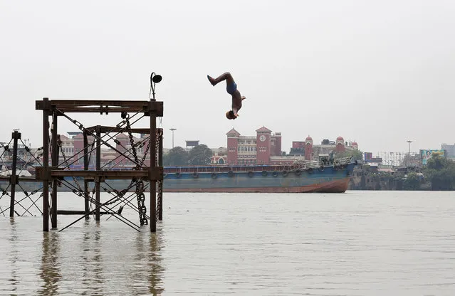 A boy jumps into the Ganges river to cool off on a hot summer day in Kolkata, India, June 3, 2019. (Photo by Rupak De Chowdhuri/Reuters)
