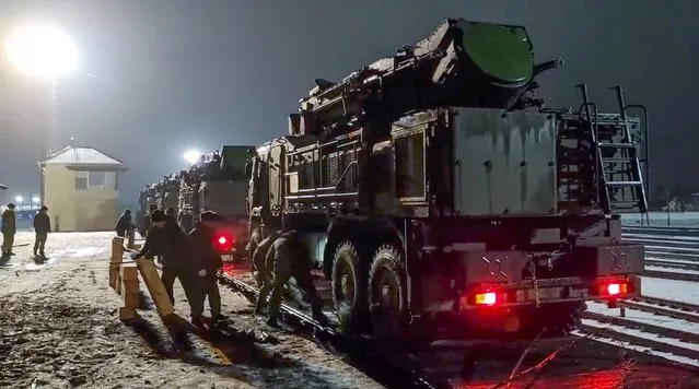 In this photo taken from video provided by the Russian Defense Ministry Press Service on Saturday, January 29, 2022, Russian military vehicles prepares to drive off a railway platforms after arrival in Belarus. In a move that further beefs up forces near Ukraine, Russia has sent an unspecified number of troops from the country's far east to its ally Belarus, which shares a border with Ukraine, for major war games next month. (Photo by Russian Defense Ministry Press Service via AP Photo)