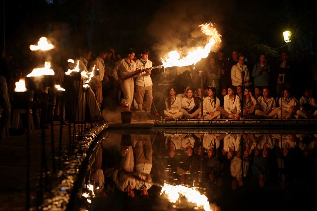Israeli scouts hold a torch as they take part in a ceremony to mark Israel's Memorial Day commemorating fallen soldiers of Israel's wars and Israeli victims of hostile attacks, amid the ongoing conflict in Gaza between Israel and the Palestinian Islamist group Hamas, at Mount Herzl military cemetery in Jerusalem on May 12, 2024. (Photo by Ronen Zvulun/Reuters)