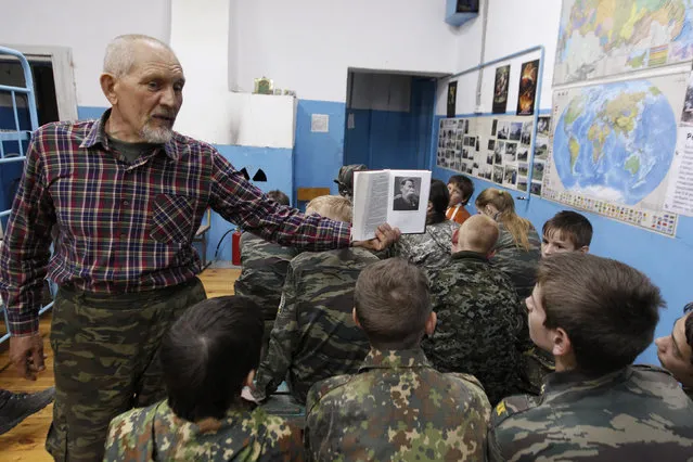 A lecturer shows students from the General Yermolov Cadet School a picture of General Mikhail Skobolev, a highly decorated and revered strategist from the 19th century, during a military history lesson during a two-day field exercise near the village of Sengileyevskoye, April 12, 2014. (Photo by Eduard Korniyenko/Reuters)