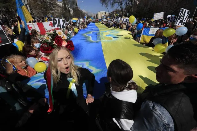 People protest during a rally against the Ukraine war in Madrid, Spain, 27 February 2022. Russian troops entered Ukraine on 24 February prompting the country's president to declare martial law and triggering a series of announcements by Western countries to impose severe economic sanctions on Russia. (Photo by Fernando Alvarado/EPA/EFE/Rex Features/Shutterstock)