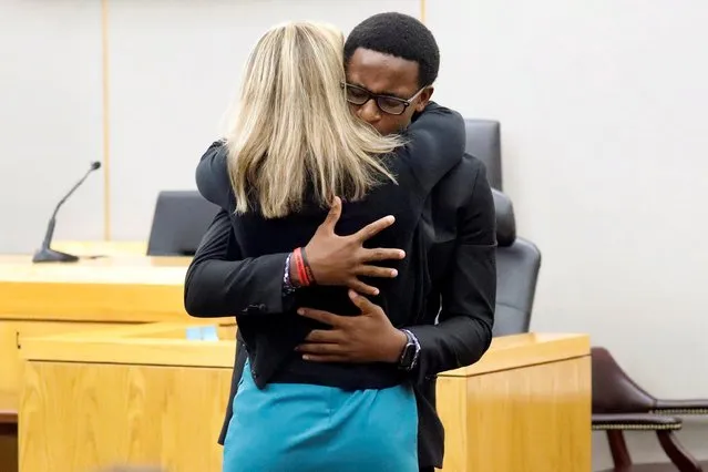 Brandt Jean hugs former Dallas police officer Amber Guyger after she was sentenced to 10 years in prison for murdering his older brother Botham Jean, in Dallas, Texas, October 2, 2019. “I forgive you, and I know if you go to God and ask him, he will forgive you. I'm speaking for myself, not my family, but I love you just like anyone else”, Brandt Jean told Guyger. The two then embraced for about a minute. (Photo by Tom Fox/Pool via Reuters)