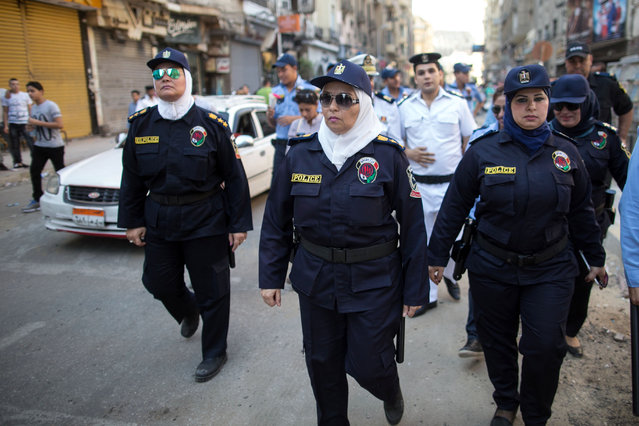 Egyptian policewomen who are part of a new anti-harassment force patrol in Cairo on the first day of Eid Al-Fitr, Friday, July 17, 2015. (Photo by Roger Anis/AP Photo)
