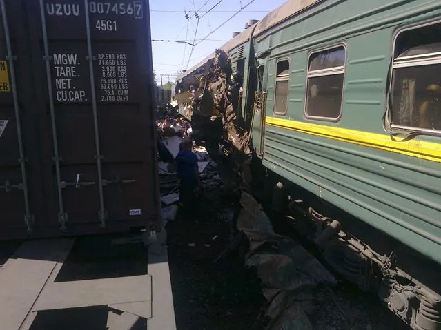 A view shows a passenger train damaged in a collision with a freight train in Moscow region in this May 20, 2014 handout photo provided by Russian Emergencies Ministry. Two trains collided near Moscow on Tuesday, causing casualties, Russia's Emergencies Ministry said. Itar-Tass news agency said the collision was between a freight train and a passenger train. Media reports of deaths could not immediately be confirmed. (Photo by Reuters/Press Service of Russian Emergencies Ministry of Moscow Region)