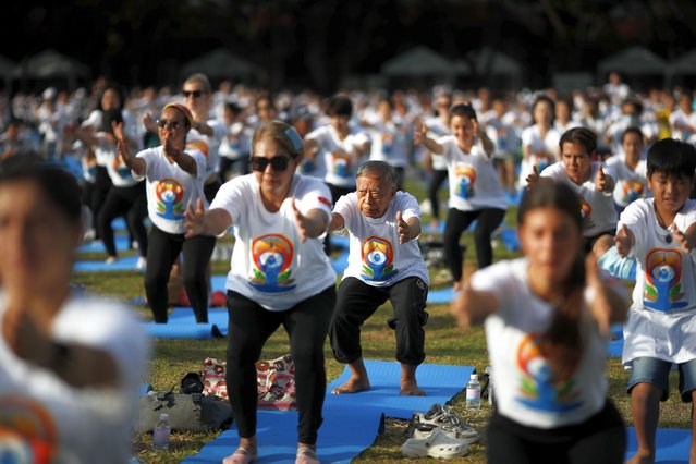 Yoga enthusiasts perform exercises during a mass yoga exercise to celebrate the International Day of Yoga in Bangkok, Thailand, 16 June 2024. Hundreds of Thai and foreign Yoga enthusiasts took part in the mass yoga exercise organized by the Indian Embassy to mark the International Day of Yoga, which is celebrated annually on 21 June to raise the public awareness on the significance of health and spiritual benefits of practicing yoga. The annual International Day of Yoga has been celebrated annually worldwide since 2015 after the United Nations declared Yoga as a practice of physical, mental and spiritual exercise which originated in ancient India. (Photo by Rungroj Yongrit/EPA)