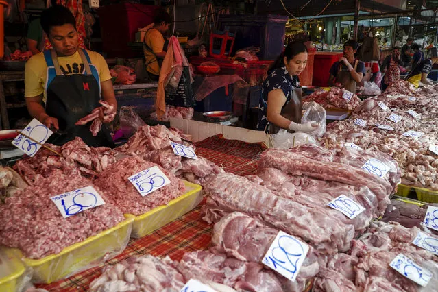 Vendors sell pork at their stall at a market in Bangkok, Thailand, March 31, 2016. (Photo by Athit Perawongmetha/Reuters)