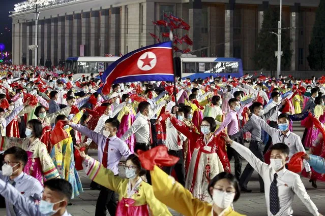 Students and youth attend a dancing party in celebration of the 110th birth anniversary of  its late founder Kim Il Sung at Kim Il Sung Square in Pyongyang, North Korea Friday, April 15, 2022. (Photo by Cha Song Ho/AP Photo)